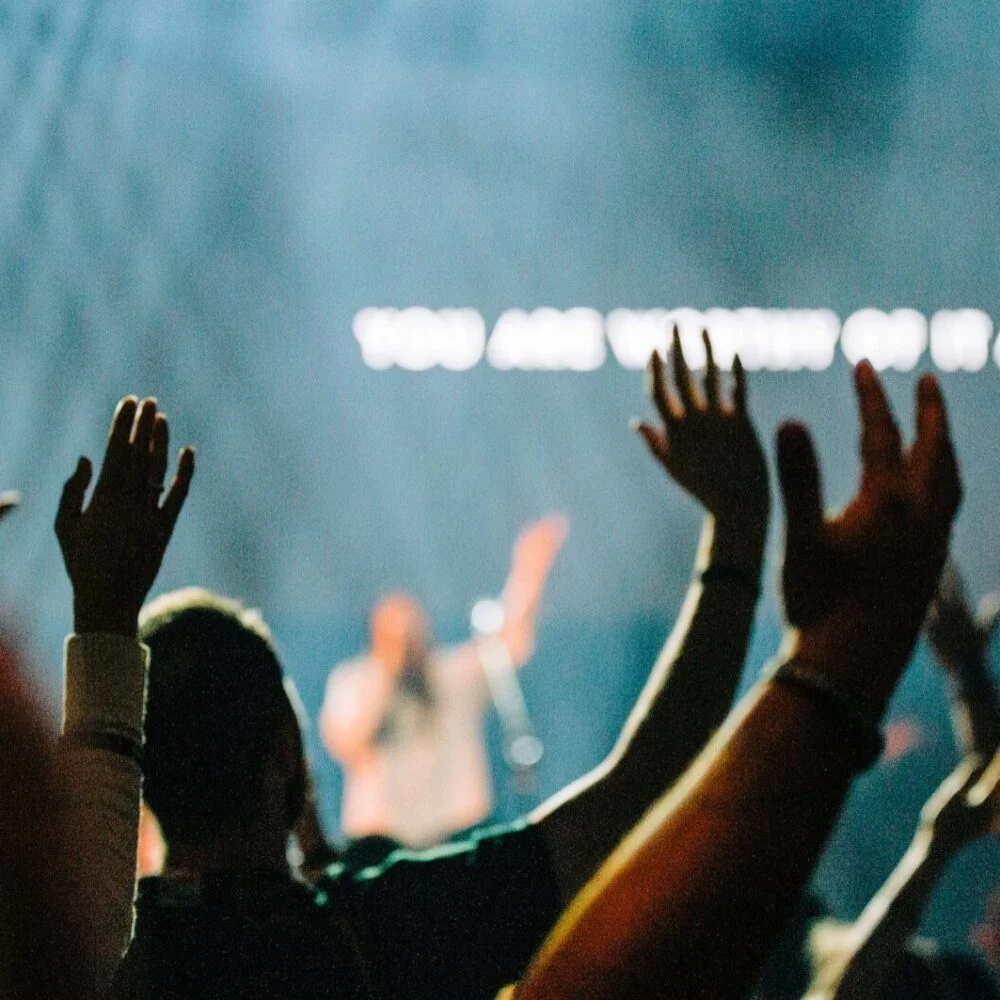 Hands raised in worship during a service