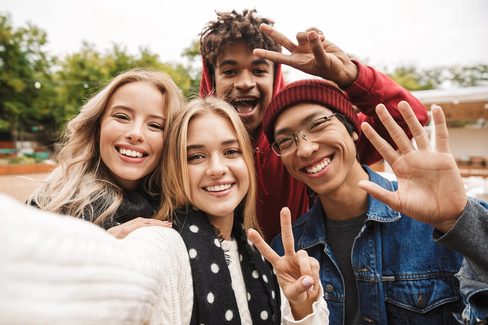 Teens laughing and taking a group selfie