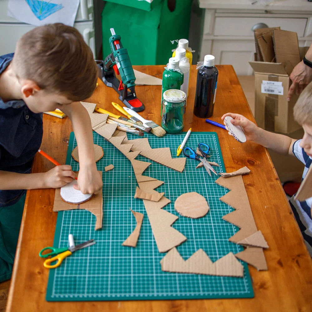 Two boys doing cardboard crafts at Vacation Bible School